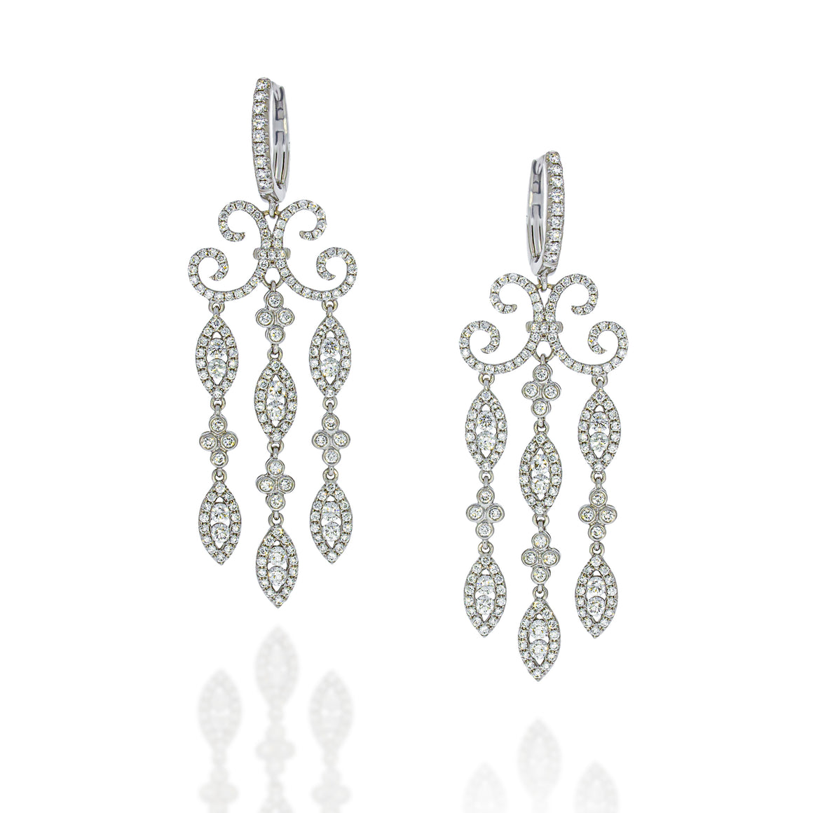 Drop earrings diamonds pave filigree swirl design. 18k white gold set with stylish pave diamonds for shaining and glamore look.